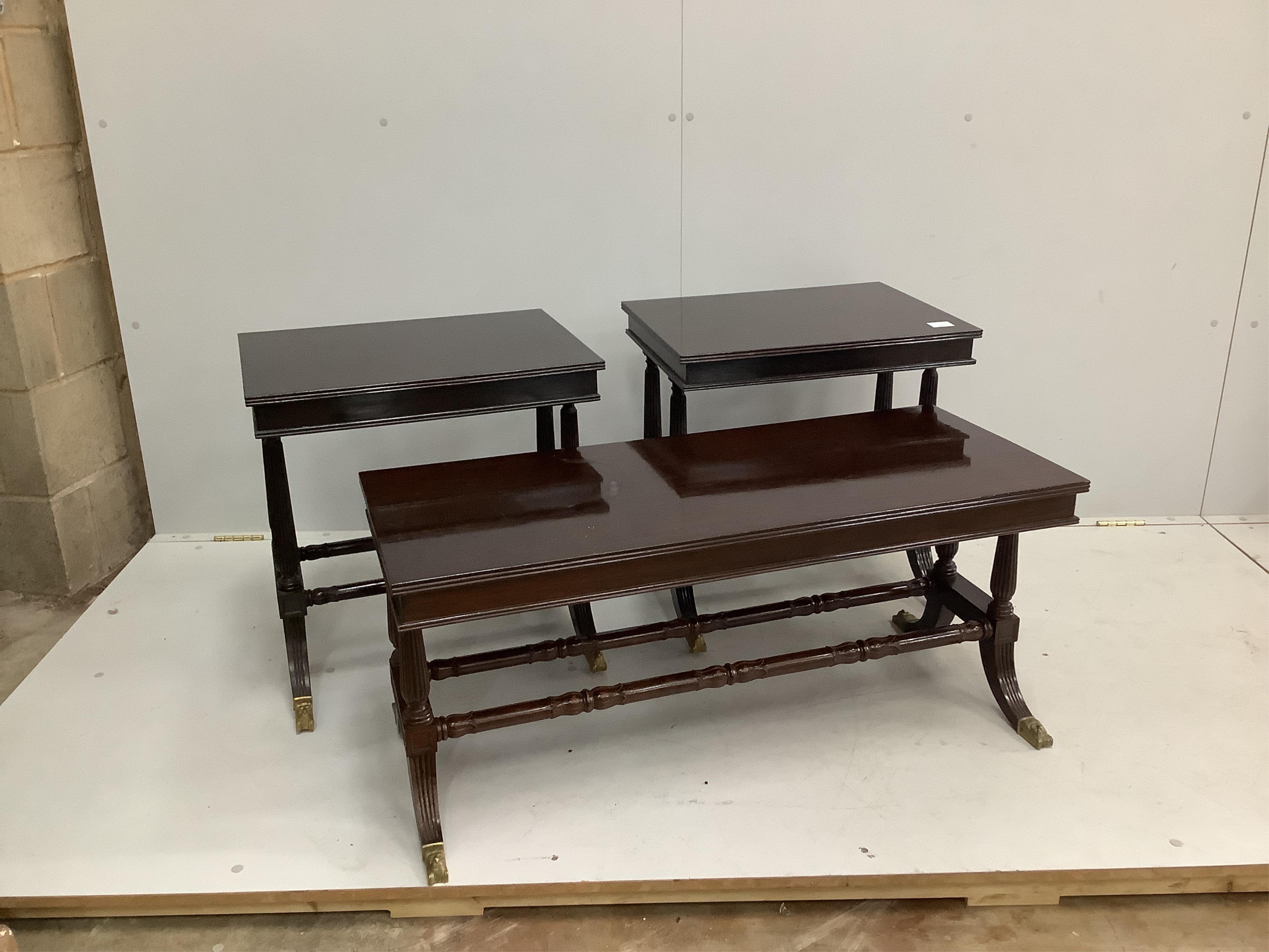A pair of Regency style rectangular mahogany occasional tables, width 56cm, depth 42cm, height 58cm, together with a matching rectangular coffee table. Condition - fair